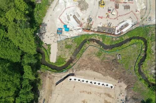 Aerial view of Stratford Brook and bridge construction near Ockham Park roundabout.