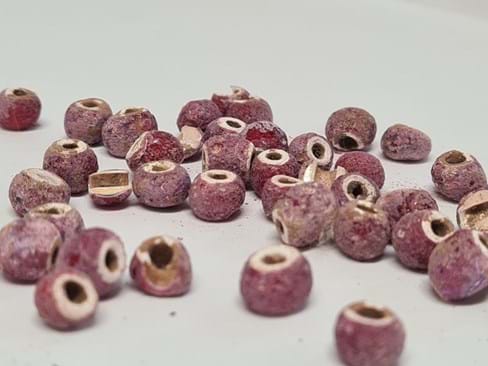 Small purple beads, some whole and some broken